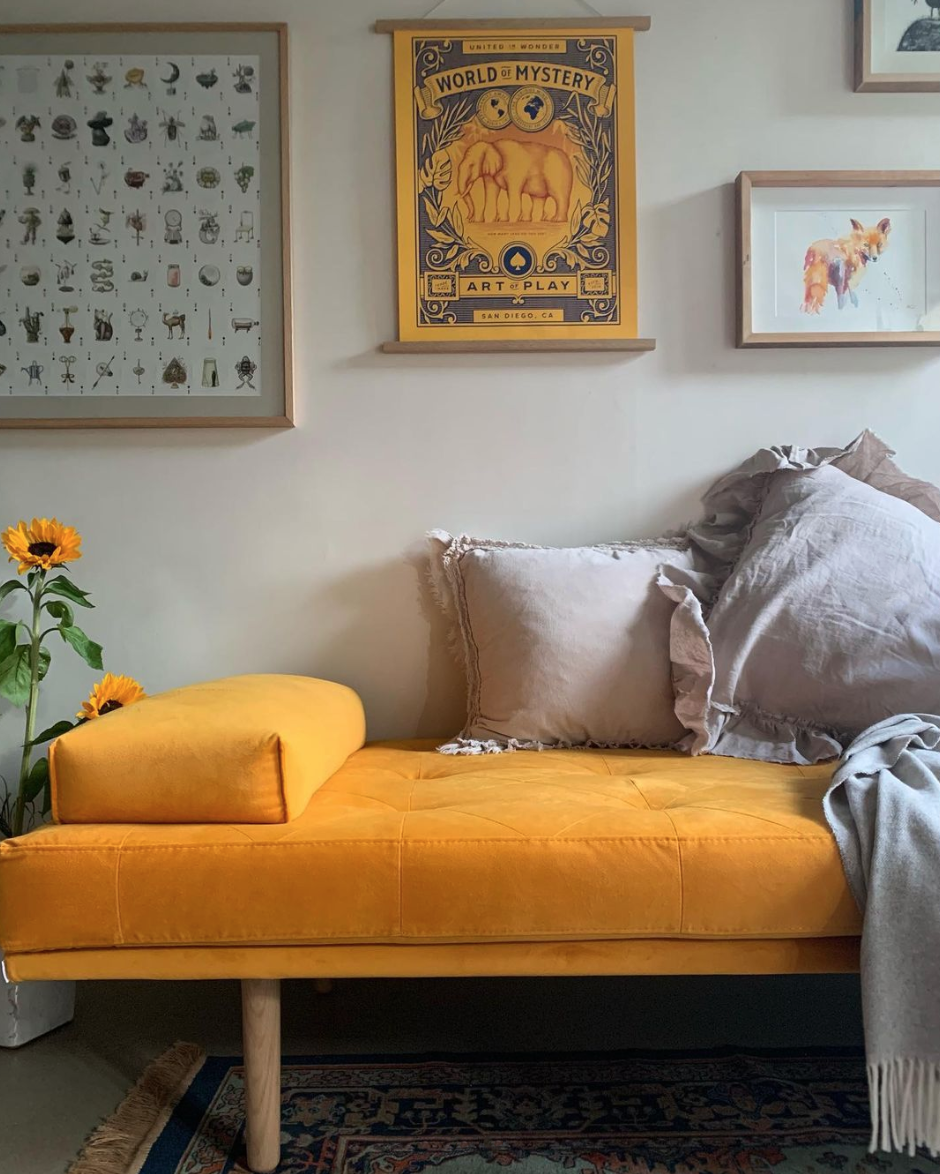 bright yellow daybed and artwork in home of @the_foxed_house