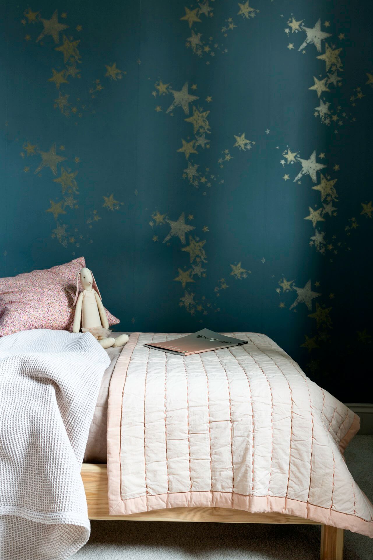 Childs bedroom with dark starry wallpaper