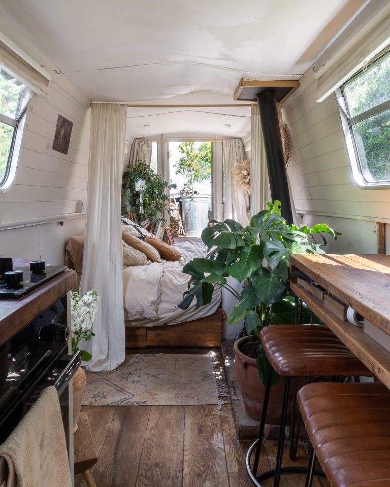 interior of a narrowboat decorated in neutral colours and plants