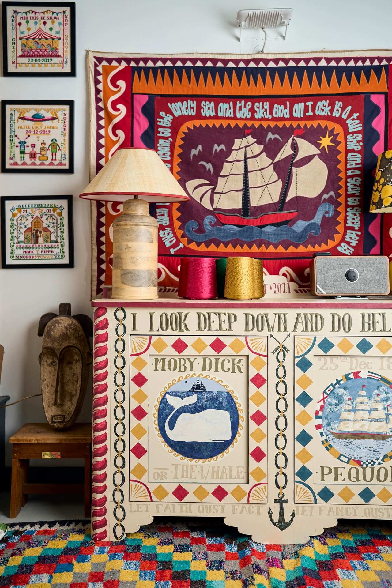 Inside Eppie Thompson founder of The Fabled Thread's embroidery studio with ship embroidery on wall