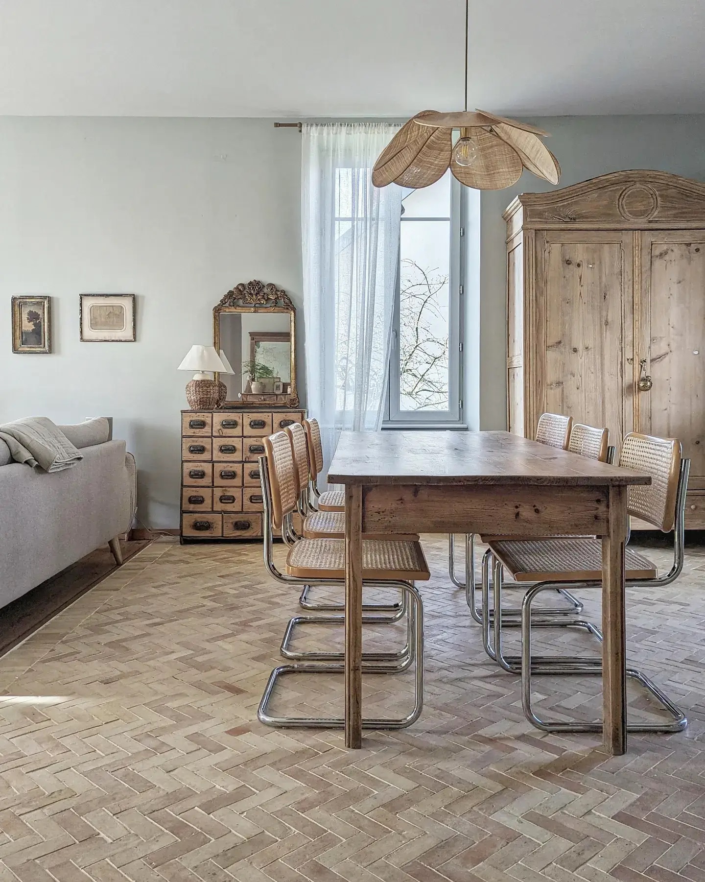 Dining room in a French home, with parquet flooring and vintage furniture 